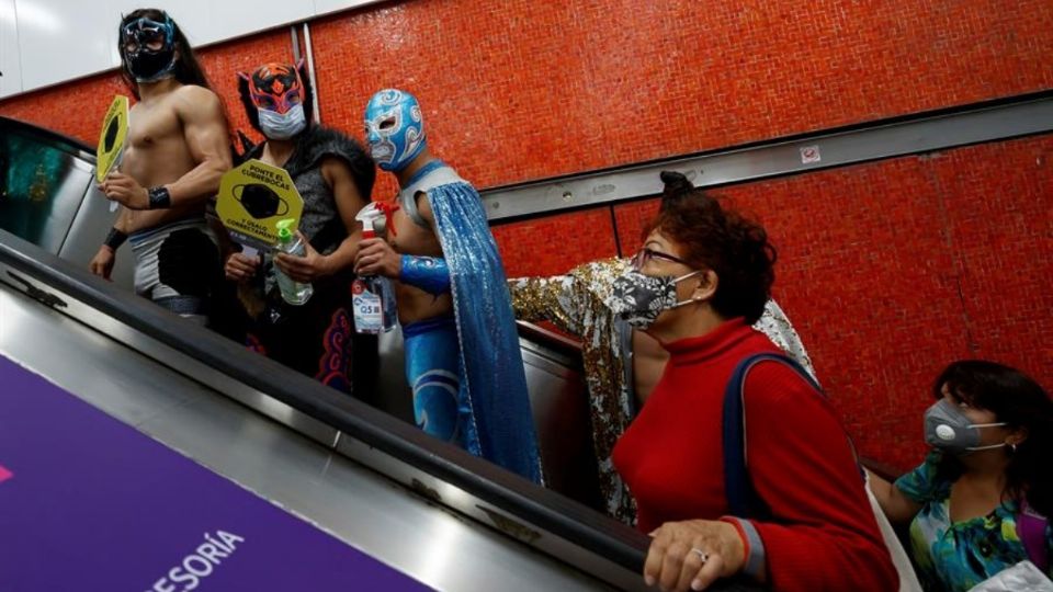 Luchadores reparten cubrebocas en Metro de la CDMX. Foto: EFE