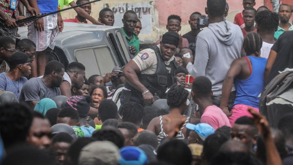 ENOJO. Una multitud enardecida rodeó un coche de Policía que transportaba a sospechosos del magnicidio. Foto: AFP
