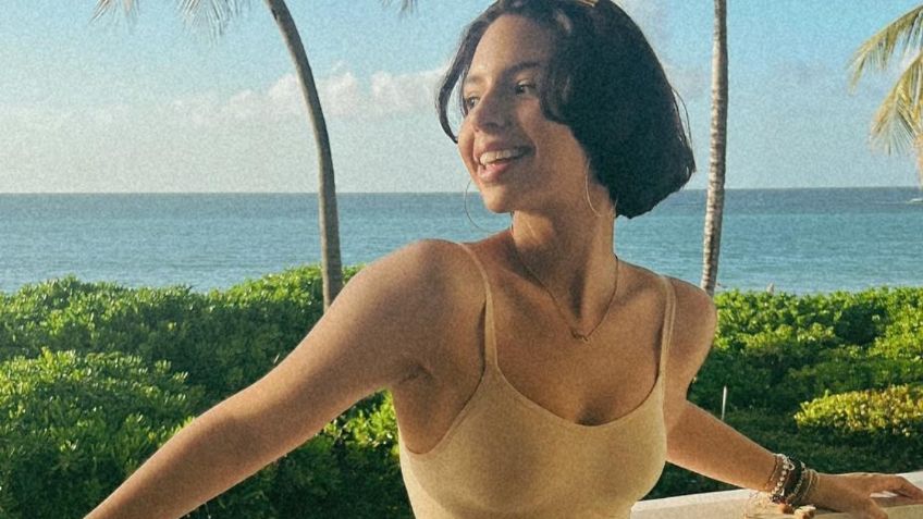 Desde un paraíso, Ángela Aguilar luce su cinturita en palatzo strapless blanco