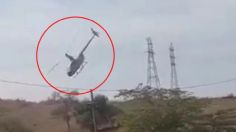 VIDEO | El impactante momento en que las hélices de un helicóptero se enredan en una línea eléctrica y se desploma