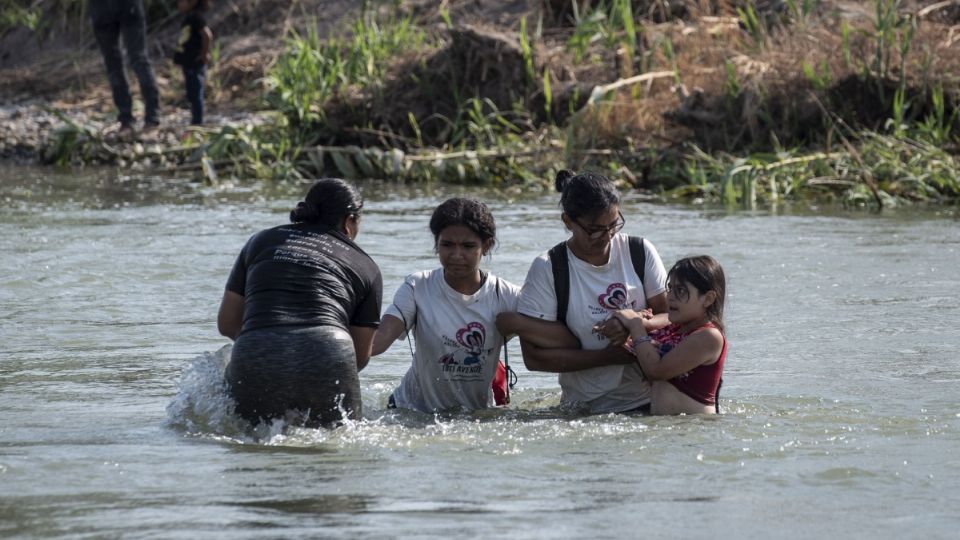 Migrantes pasan por el Río Bravo y por las boyas de púas