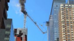 Momento en que una grúa se incendia y destruye parte de un edificio en NY: los escombros golpean a un bombero