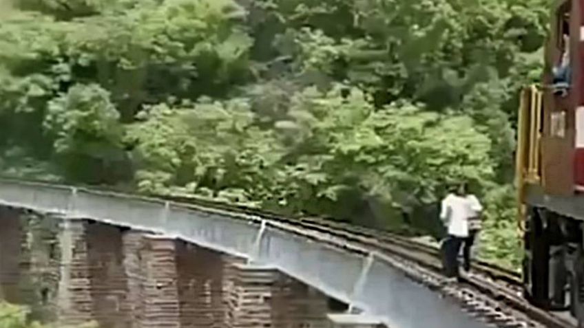 IMÁGENES FUERTES: pareja salta de puente para no ser arrollados por un TREN, tomaban fotos de su boda